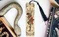 a snake, a bookmark, and some books on a table