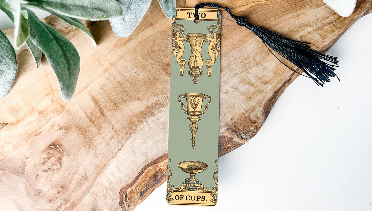 a bookmark with a tassel on top of a piece of wood