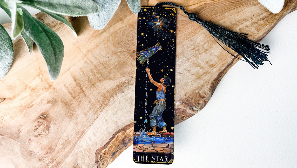 a bookmark with a painting of a man holding a star