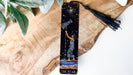 a bookmark with a painting of a man holding a star