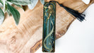 a wooden piece with a tassel hanging from it