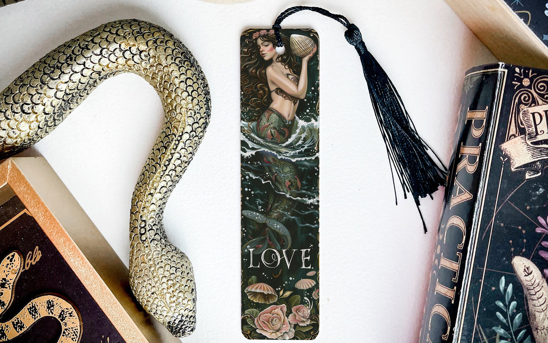 a bookmark with a snake on it next to books