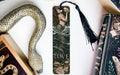 a bookmark with a snake on it next to books