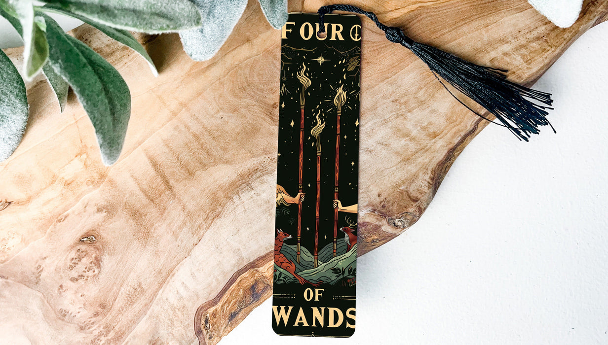a bookmark with a tassel on top of a piece of wood