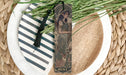 a bookmark with a picture of a woman and a deer on it