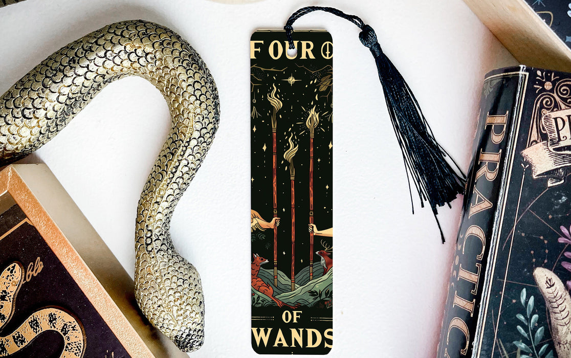 a bookmark with a snake on it next to other books