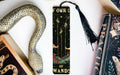 a bookmark with a snake on it next to other books