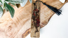 a wooden cross with a tassel hanging from it