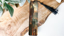 a bookmark with a painting of a castle on it