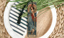 a bookmark with a picture of a woman and a cat on it