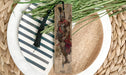 a wooden bookmark sitting on top of a white plate