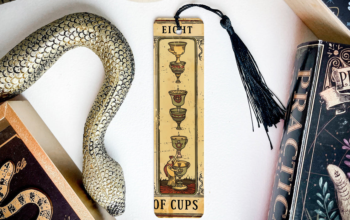 a bookmark with a snake and a cup on it