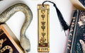 a bookmark with a snake and a cup on it