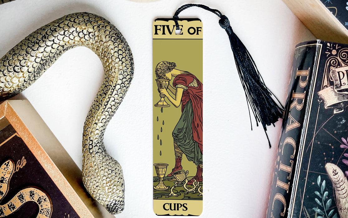 a bookmark with a picture of a woman holding a snake