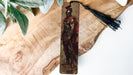 a wooden object with a tassel hanging from it