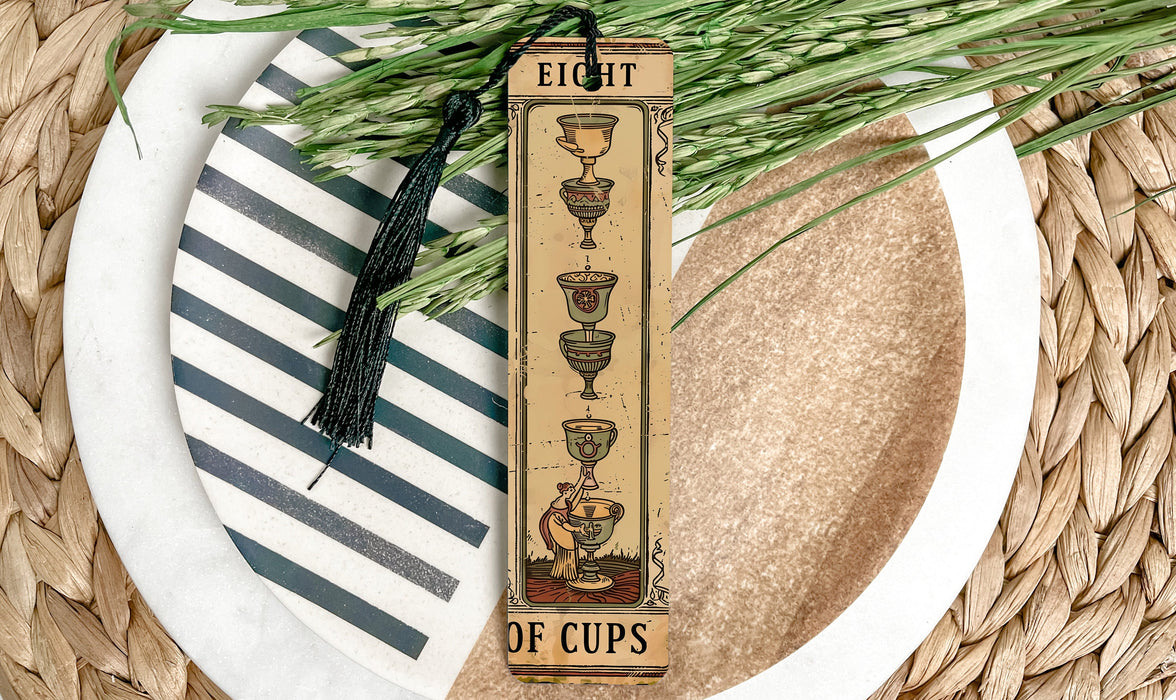 a tall bookmark with a tassel on top of a plate