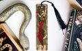 a bookmark with a snake and a woman on it