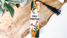 a bookmark that says stay positive on it