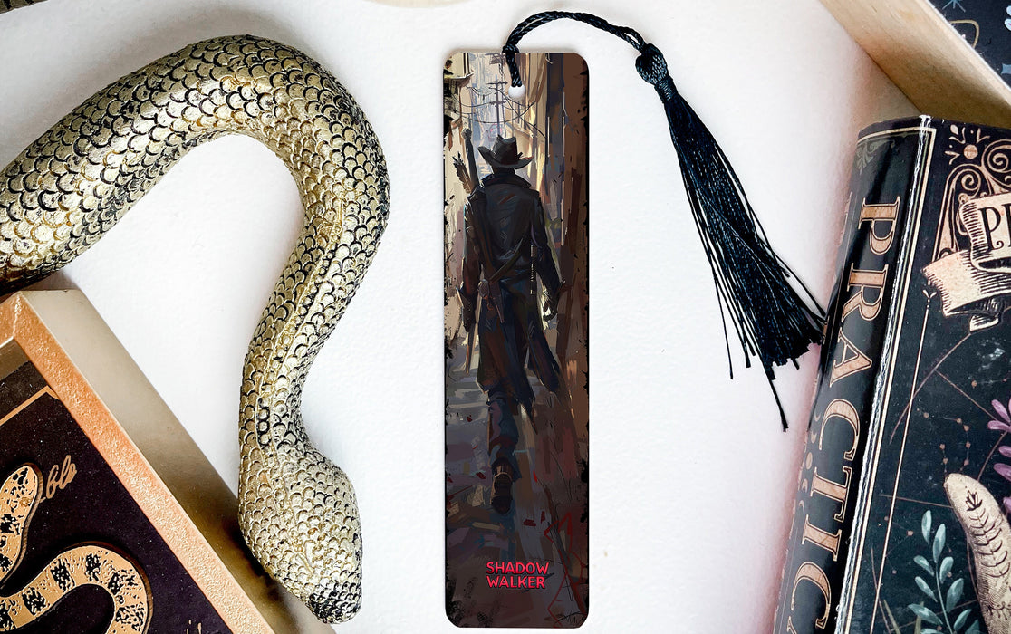 a snake, a bookmark, and some books on a table