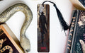 a snake, a bookmark, and some books on a table