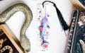 a bookmark with a snake and flowers on it