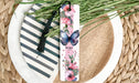 a close up of a plate with a flower bookmark