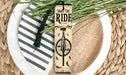 a bookmark with a bike on it sitting on a plate