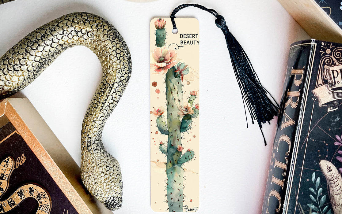 a bookmark with a tassel and a snake next to it