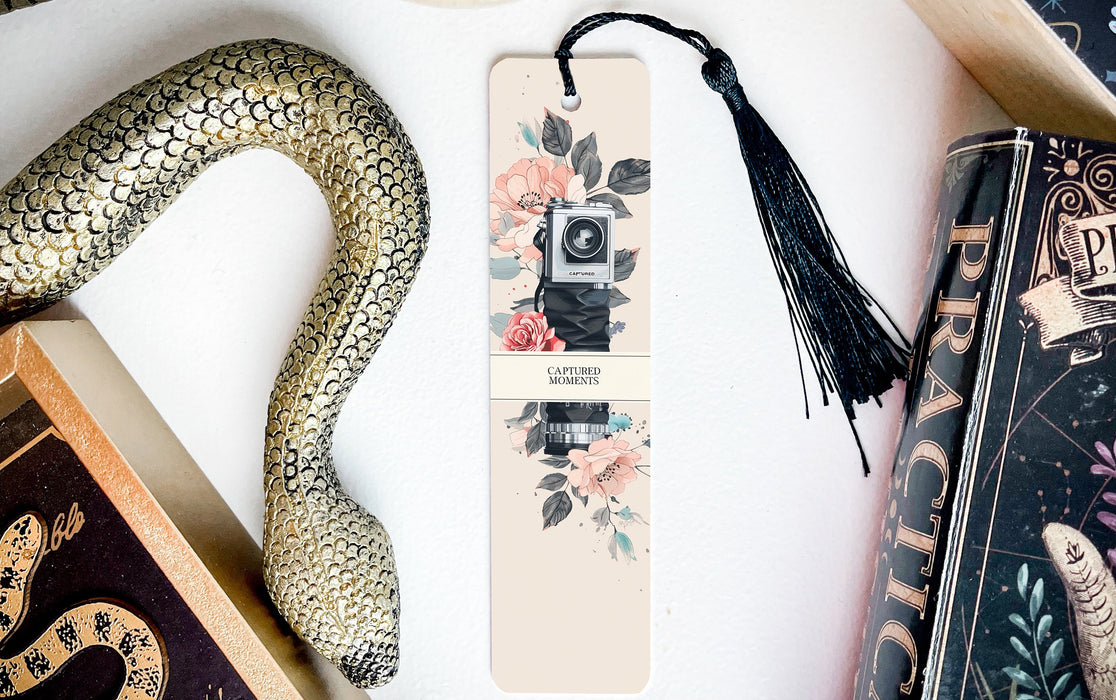 a snake, a book, and a camera on a table