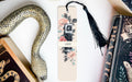 a snake, a book, and a camera on a table