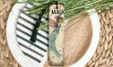 a bookmark with a fairy on it sitting on a plate