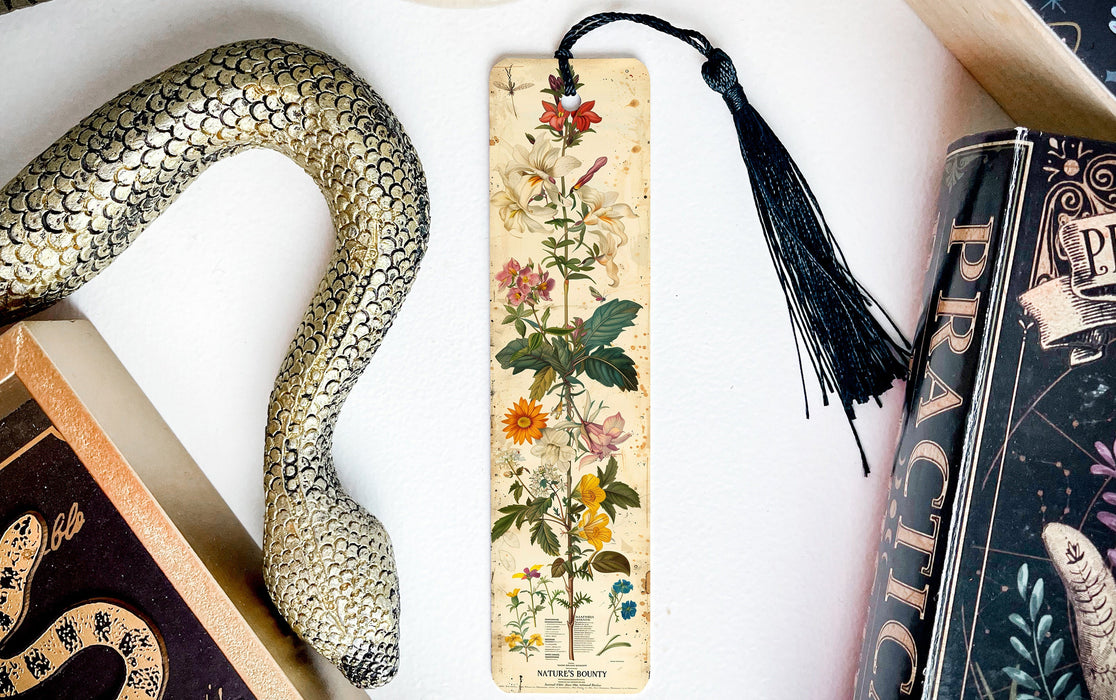 a snake, a bookmark, and two books on a table