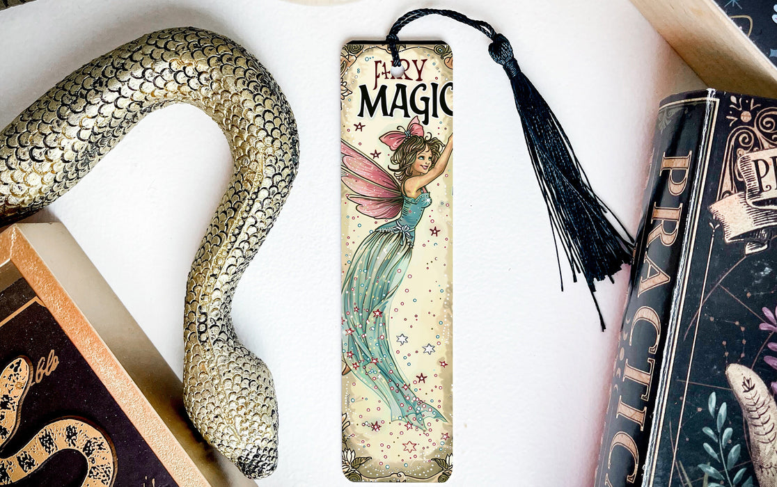 a bookmark with a fairy on it next to a snake