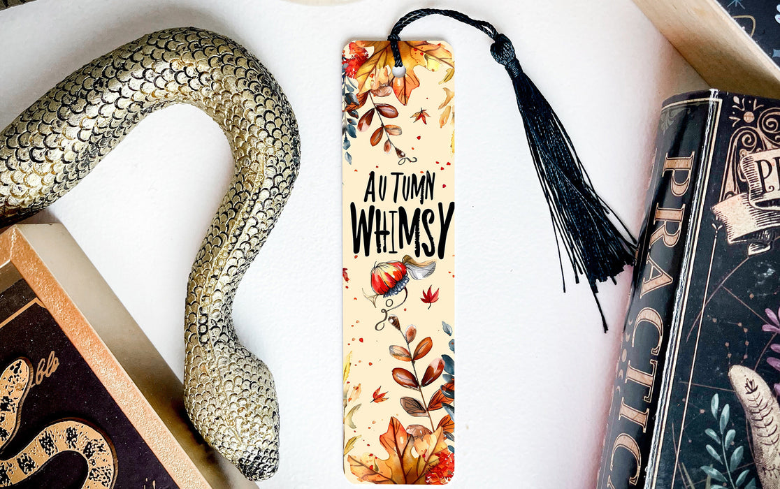 a bookmark with a snake on it next to books