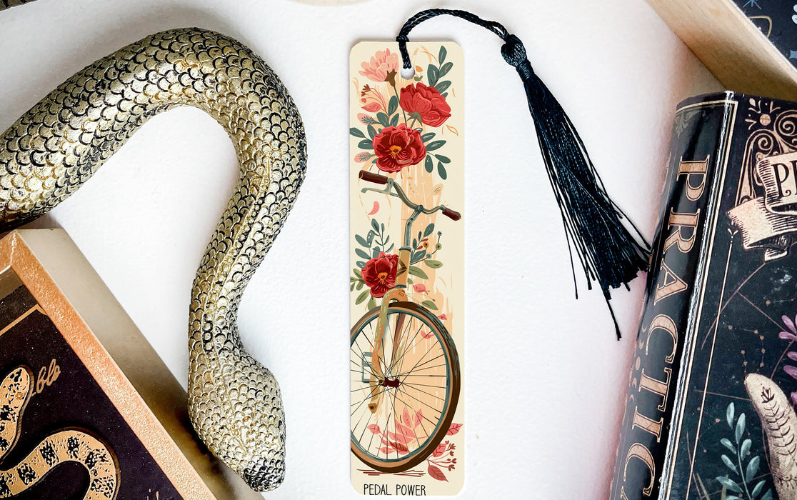 a snake, a bookmark, and some books on a table
