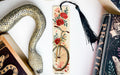 a snake, a bookmark, and some books on a table
