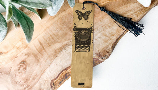 a wooden bookmark with a typewriter on it