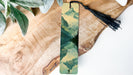 a wooden board with a tassel on top of it