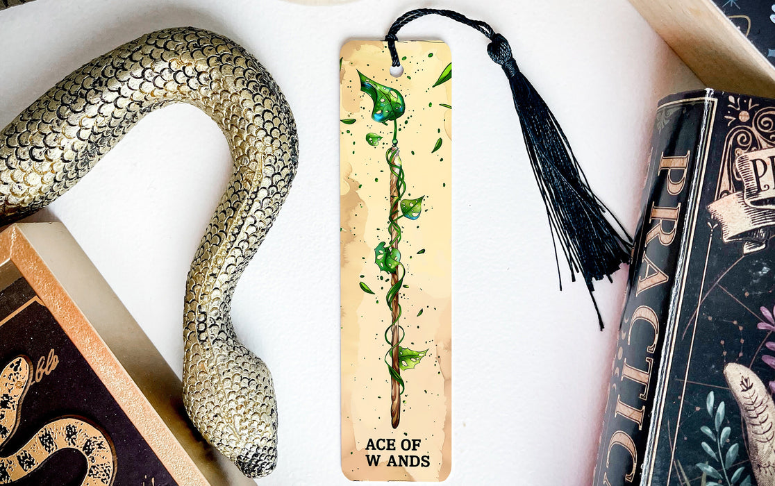 a bookmark with a snake and a book on it
