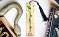 a bookmark with a snake and a book on it