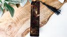 a wooden cross with a painting of jesus on it