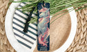 a close up of a plate of food with a unicorn bookmark
