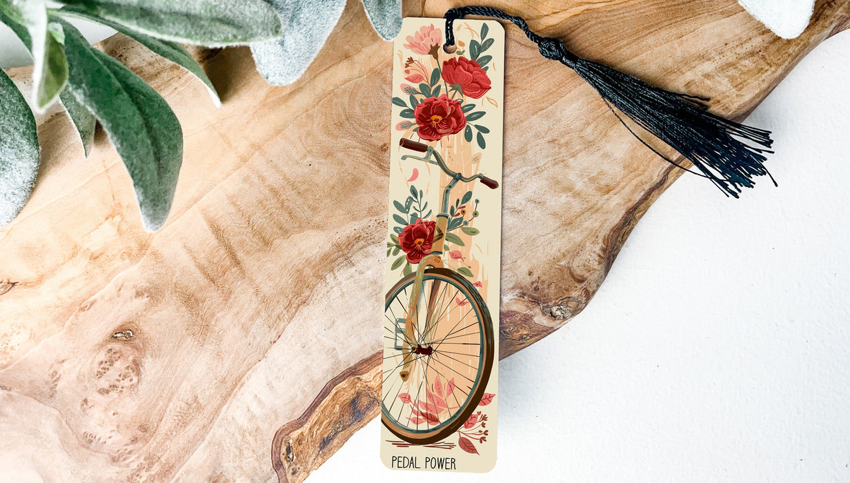 a bookmark with a bicycle and flowers on it