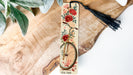 a bookmark with a bicycle and flowers on it
