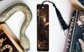 a bookmark with a painting of a man reading a book