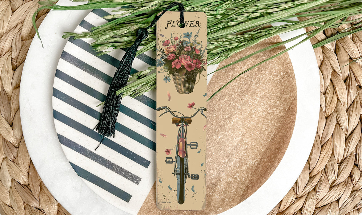 a bookmark with a bicycle and flowers on it
