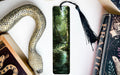 a bookmark with a snake and a book on it