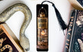 a bookmark with a snake on it next to some books