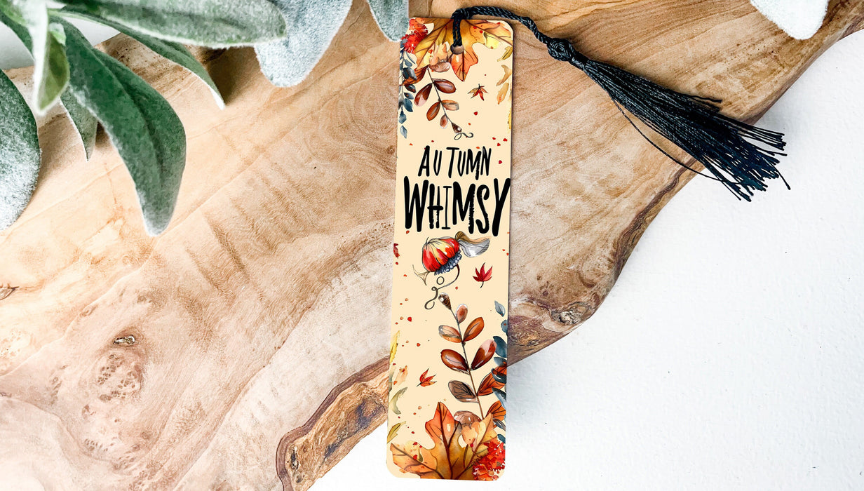 a bookmark with a tassel on top of a piece of wood