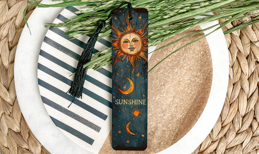a sun and moon bookmark on a plate